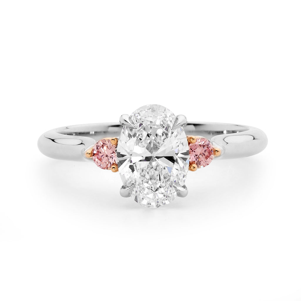 Three stone oval cut pink and white diamond ring